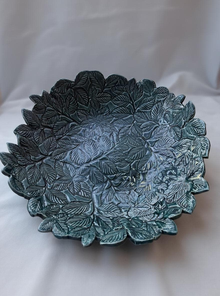 Sculptural ceramic piece with a nature-inspired motif